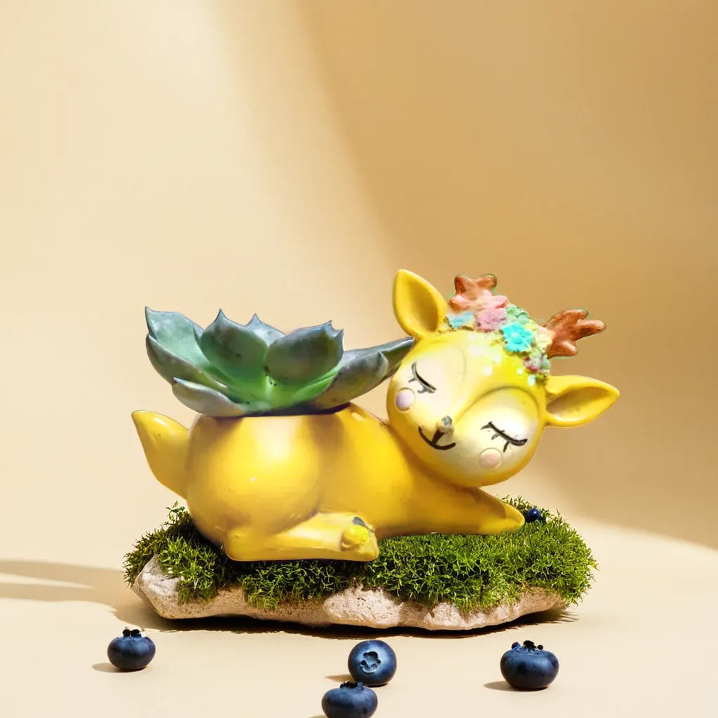 Charming deer-shaped planter with decorative antlers, perfect for displaying succulents or small indoor plants. This whimsical planter adds a touch of nature and playfulness to any indoor space. Discover unique and decorative succulent pots like this at Plant Orbit.