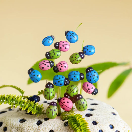 Colorful ladybug miniatures in blue, pink, and green, perfect for enhancing your miniature garden setup. These charming garden miniature toys add a playful and vibrant touch to any miniature garden display or accessory collection. Explore unique miniature garden accessories like these at Plant Orbit.