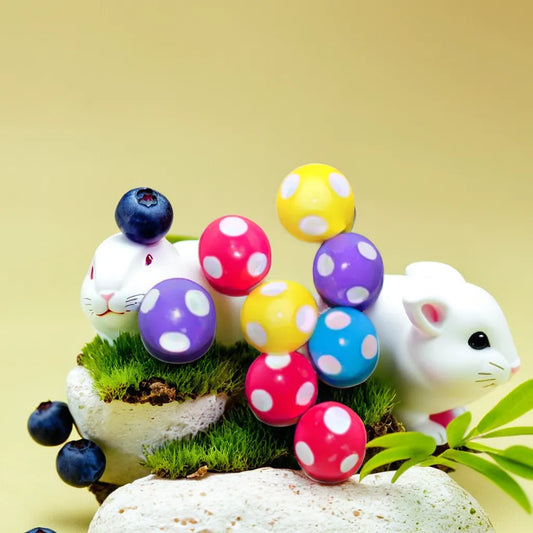 Set of colorful mini mushroom miniatures in red, purple, blue, and yellow with polka dots, ideal for adding a whimsical touch to your miniature garden. These miniature garden accessories enhance playful displays and creative garden scenes. Discover unique miniature garden toys like these at Plant Orbit.