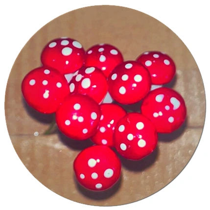 Collection of vibrant red miniature mushrooms with white polka dots, perfect for decorating indoor plant arrangements and succulent displays. Find unique miniatures like this at Plant Orbit, enhancing your indoor plants, succulents, and cactus collections with charming details.