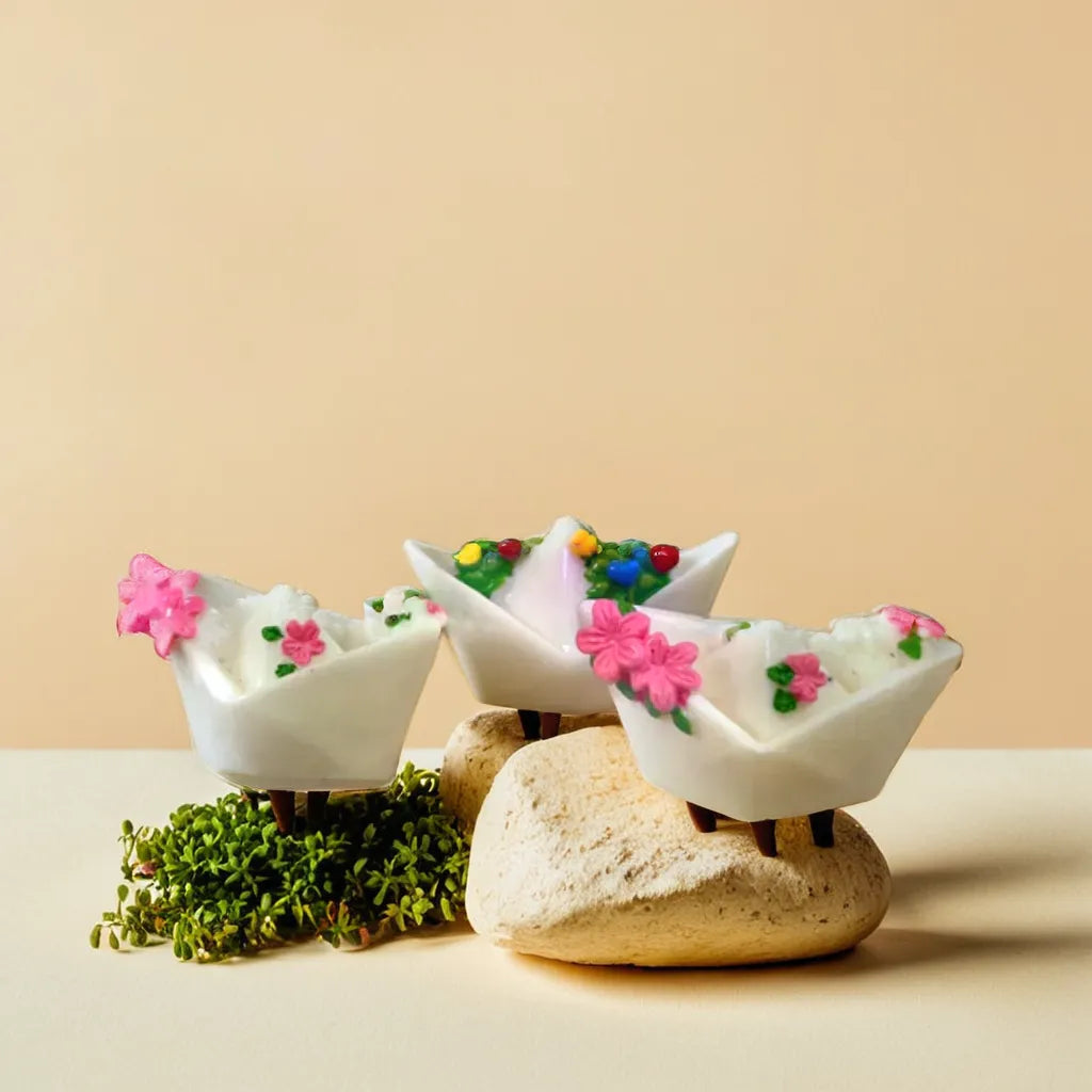 Tricolor boat miniatures adorned with pink flowers and decorative details, perfect for enhancing a whimsical miniature garden scene. These miniature garden accessories add a creative and charming touch to garden displays or toy collections. Explore unique garden miniature toys like these at Plant Orbit.